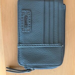 The Sak pebble leather card wallet in teal.